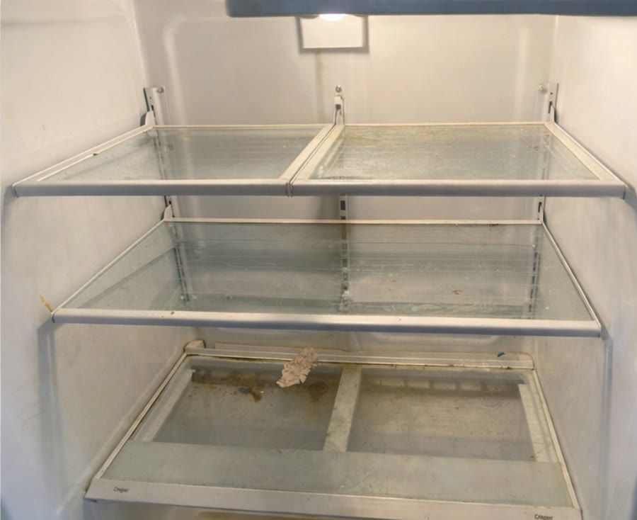 Refrigerator interior before detailed cleaning